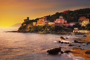 a group of houses on a hill next to the ocean at IlMareaDuePassi Guest House in Rosignano Solvay