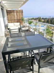 een glazen tafel en stoelen op een balkon bij Appartement Mijas in Mijas Costa