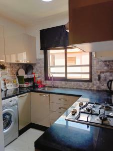 a kitchen with a sink and a stove top oven at Charmant appartement équipé près de Guéliz in Marrakech