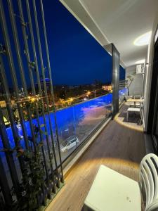 a balcony with a view of a pool at night at Ideal Apartment Shkoder in Shkodër