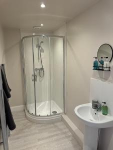 a bathroom with a shower and a sink at Luxury 5 bedroom house - sleeps 10 in Colkirk