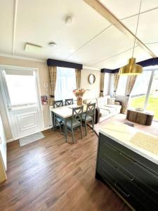 a living room with a table and a couch at The Driftwood Den in Tywardreath +29 photos