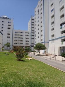 a walkway in front of a building with a park at Great value 5 mins to Praia de Rocha beach in Portimão