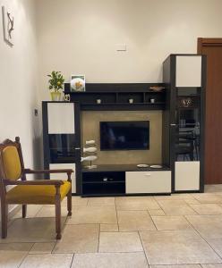 a living room with a large entertainment center with a television at Palmieri Cozy Stay in Monopoli