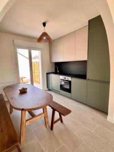 a kitchen with a wooden table and a dining room at Charmante Maison avec Terrasse in Angers