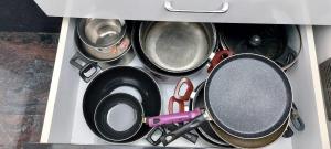 a group of pots and pans in a drawer at Crystal Stay Villa in Chikmagalūr
