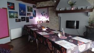 a dining room with a long table with chairs at Chambres d'hôtes - Domaine Beau Sejour in Biaudos