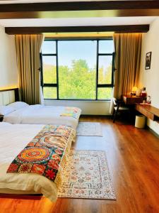 Postel nebo postele na pokoji v ubytování Kashgar QIu Ge Homestay