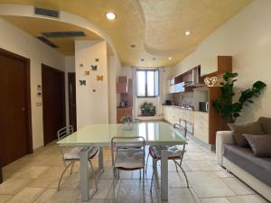a kitchen and living room with a table and a couch at Palmieri Cozy Stay in Monopoli