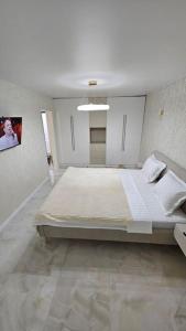 a large white room with a large bed in it at Квартира в Бендерах VIP in Bender