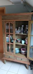 a cabinet with plates and dishes in it at Romantische Ferienwohnung Rheingold 50 qm für 2 bis 4 P in Bacharach