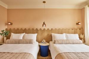 two beds sitting next to each other in a room at The Beacon in Salter Path