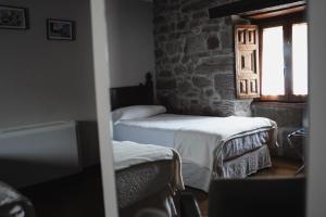 Postel nebo postele na pokoji v ubytování Hotel Rural LATORRIÉN DE ANE