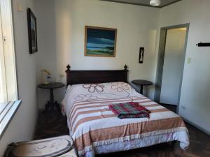 a bedroom with a bed with a blanket on it at Recanto da Cancela in Penha