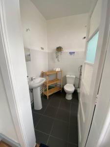 a bathroom with a toilet and a sink at Rota Ria Alojamento Local in Aveiro +60 photos