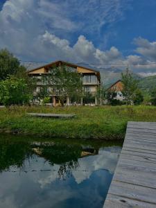 a house sitting next to a body of water at Beko’s garden Inn in Mestia