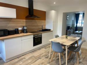 a kitchen with a table and a table and chairs at Gite 2 du grand Pavillon in Rocroi
