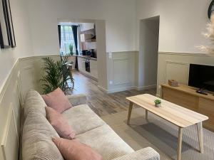 a living room with a couch and a table at Gite 2 du grand Pavillon in Rocroi