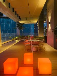a room with a table and chairs in a building at Axon Infinity Pool KL in Kuala Lumpur