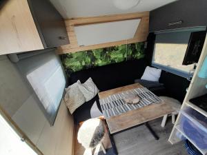 an aerial view of an rv with a table and a couch at Tepe Retreat in Konjšica
