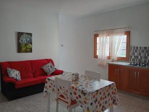 a living room with a red couch and a table at Victoria 2 in Tejeda