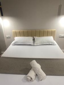 a white bed with a towel laying on it at ЖК Алма Сити in Raimbek