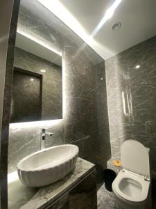 a bathroom with a sink and a toilet at ЖК Алма Сити in Raimbek