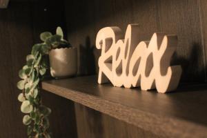 a shelf with a plant and a sign that says raigun at Terrace44 Oasi di pace e relax nel cuore di Trieste in Trieste +29 photos