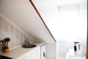 a white kitchen with a sink and a window at Apartamento en Somo con 2 plazas de garaje in Somo