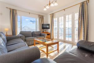 a living room with two couches and a table at Villa Adella in Tías
