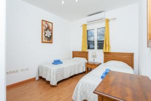 a bedroom with two beds and a window at Villa Adella in Tías +31 photos