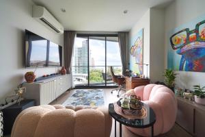 a living room with a couch and a table at EDGE Central Pattaya 2BR Ocean View Luxury Condo Rooftop Pool Central Location in Pattaya