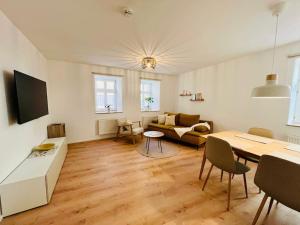 a living room with a couch and a table at FeelingHomeApartment in Dinkelsbühl