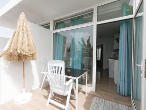 a dining room with a table and a chair at Paisaje Lunar in Tinajo +11 photos