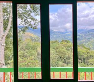 a window with a view of a mountain view at Hostal Bamboo in Salento