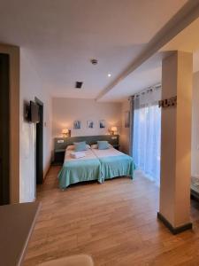 a bedroom with a bed and a large window at La casa en el Mar in Almayate Alto