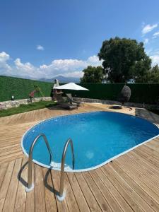 a small pool with a chair next to a wooden deck at Müngen Bungalovs in Kemer