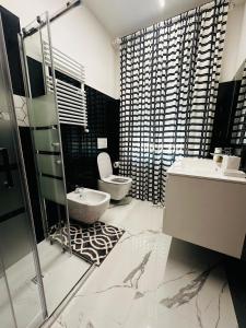 a bathroom with a toilet and a sink and a shower at La Casa Rossa in Ca' di David +27 photos