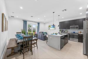 a kitchen and dining room with a table and chairs at Delray Oasis - Private Pool - Fenced Yard - Parking - Laundry - Full Kitchen - Convenient Location in Delray Beach
