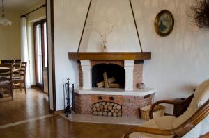 a living room with a brick fireplace in a house at Apartment Luno in Zvoneće