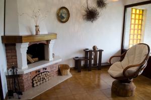 a living room with a fireplace and a chair at Apartment Luno in Zvoneće
