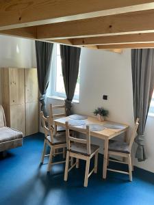 a dining room with a wooden table and chairs at Apartment FOX in Kořenov
