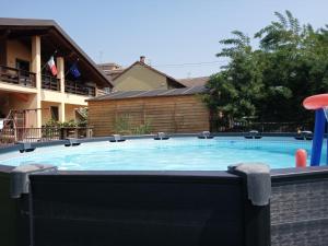 a large swimming pool with a inflatable at G&G Giusy e Gabry in Santhià