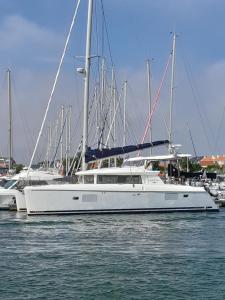 a white boat is docked in a harbor at Maol in Saint-Gilles-Croix-de-Vie