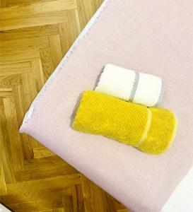 a pair of towels sitting on top of a floor at Saltwater Apartment Gdynia in Gdynia