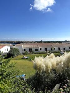 a view of a yard with a house in the background at Casita Estrella in Arenal d'en Castell