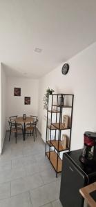 a dining room with a table and a shelf at Alex House in Făgăraş