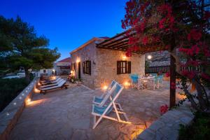 a house with a patio with chairs and a table at Villa Ftenagia in Halki