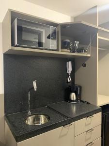 Η κουζίνα ή μικρή κουζίνα στο Flat MOVE proximo ao mar