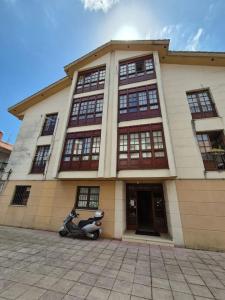 a scooter parked in front of a building at Barquiña Beach House in the heart of San Vicente in San Vicente de la Barquera